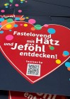 Grafik mit QR Code und Herzmotiv, auf dem steht: "Fastelovend mit Hätz und Jeföhl entdecken"