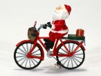 Eine Figur, die einen Weihnachtsmann auf einem roten Fahrrad zeigt. Vorne und hinten sind Geschenke zu sehen.