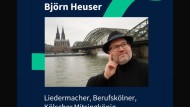Zu sehen ist ein Screenshot von Instagram. Herr Björn Heuser hat auf einen Post des Kanals "Alltag und Sprache im Rheinland" reagiert. Dieser Post zeigt ihn selbst, einen Mann mit Hut, Brille und Bart, der nachdenklich vor dem Rhein mit Kölner Dom im Hintergrund steht. Darunter steht: "Liedermacher, Berufskölner, Kölscher Mitsingkönig". Er bedankt sich schriftlich: "Ein sehr gelungenes Interview, danke für das wunderbare Gespräch und eure wertvolle Arbeit!" Dahinter steht ein Herz-Emoji.