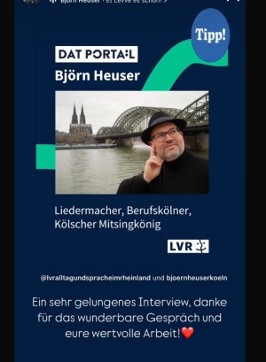 Zu sehen ist ein Screenshot von Instagram. Herr Björn Heuser hat auf einen Post des Kanals "Alltag und Sprache im Rheinland" reagiert. Dieser Post zeigt ihn selbst, einen Mann mit Hut, Brille und Bart, der nachdenklich vor dem Rhein mit Kölner Dom im Hintergrund steht. Darunter steht: "Liedermacher, Berufskölner, Kölscher Mitsingkönig". Er bedankt sich schriftlich: "Ein sehr gelungenes Interview, danke für das wunderbare Gespräch und eure wertvolle Arbeit!" Dahinter steht ein Herz-Emoji.